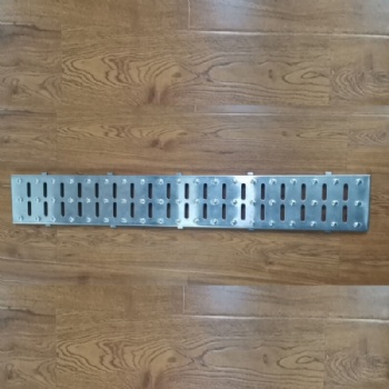 Slotted stamped drainage channel cover
